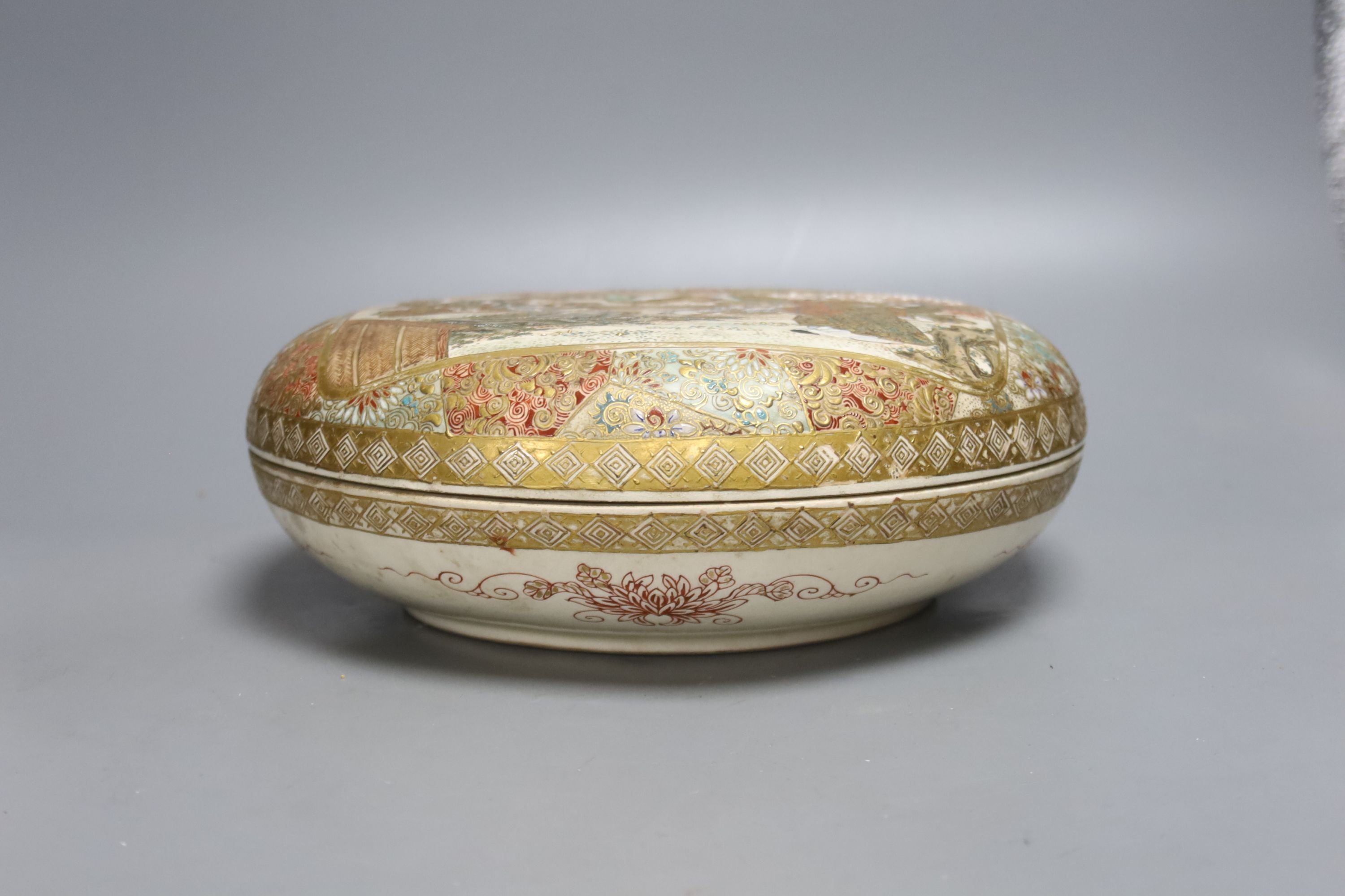 A late 19th century Japanese Satsuma box and cover, painted and gilded throughout, 23cm diameter